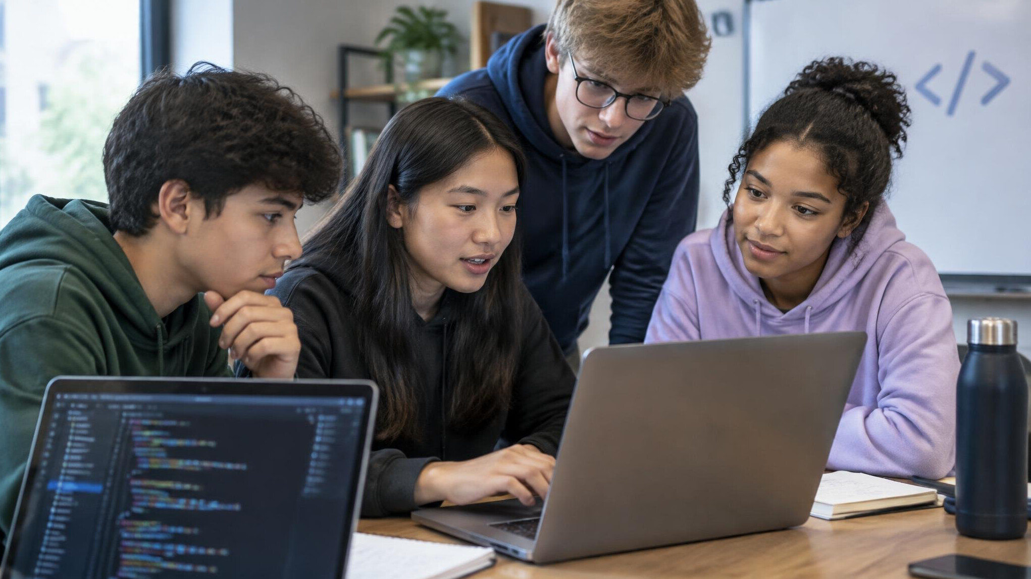 group of teens coding together