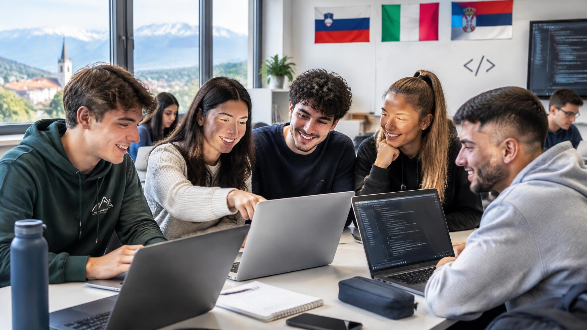 Group of diverse students learning programming together on laptops in a bright classroom