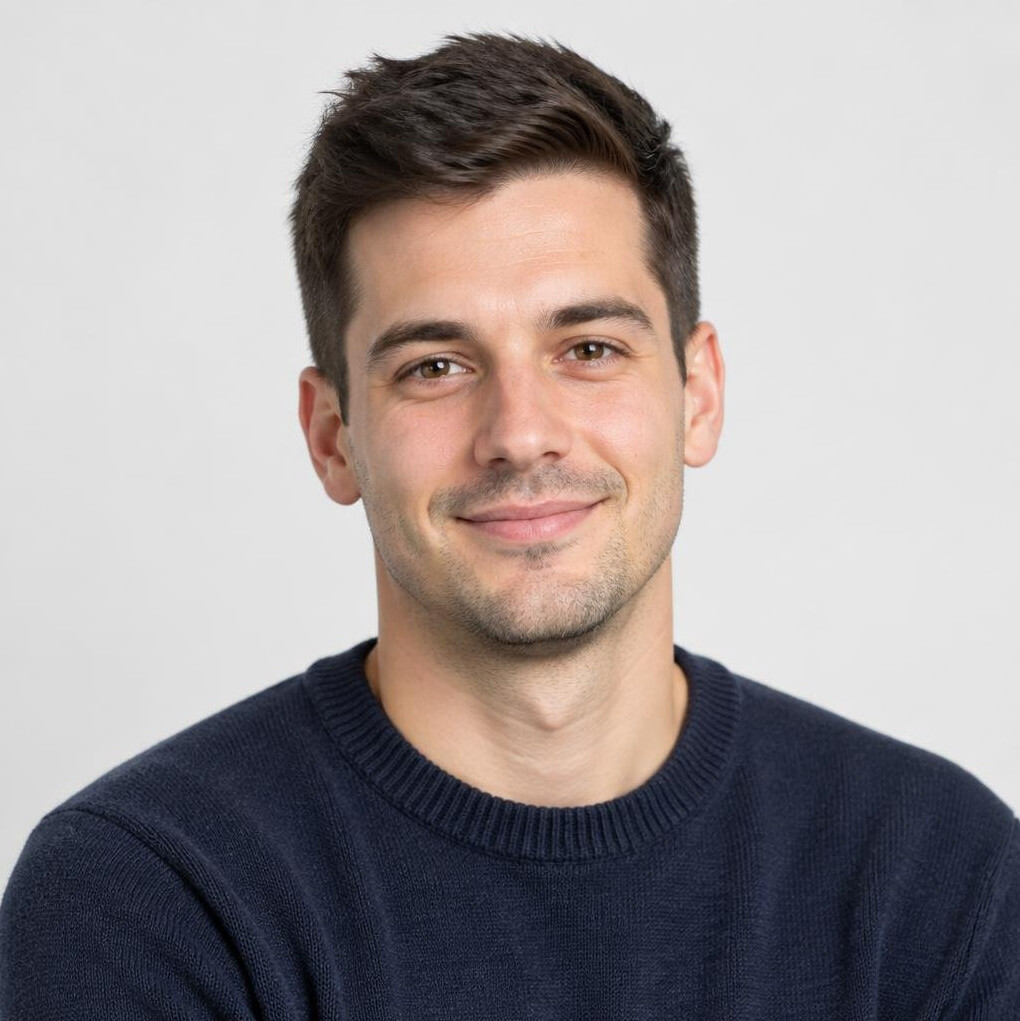Studio portrait of a young man with short dark hair smiling