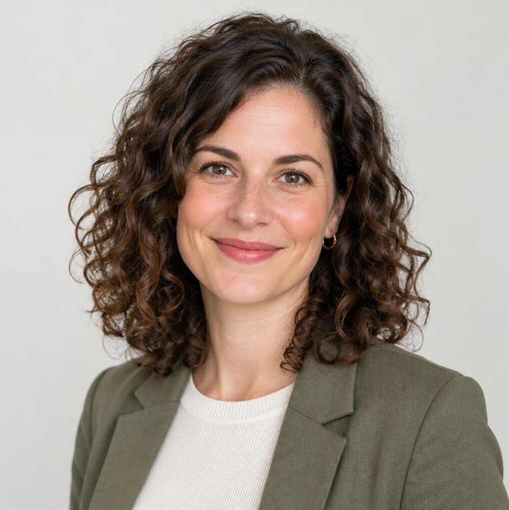 Studio portrait of a woman with curly hair smiling